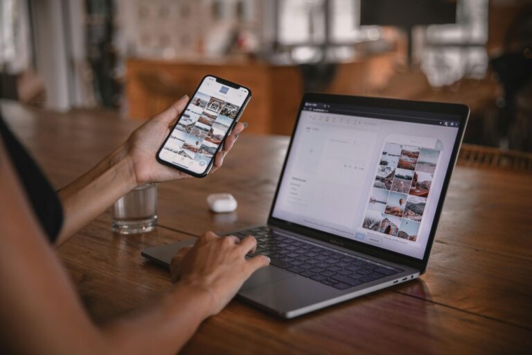 a person holding a phone and typing on a laptop to find a right influencer